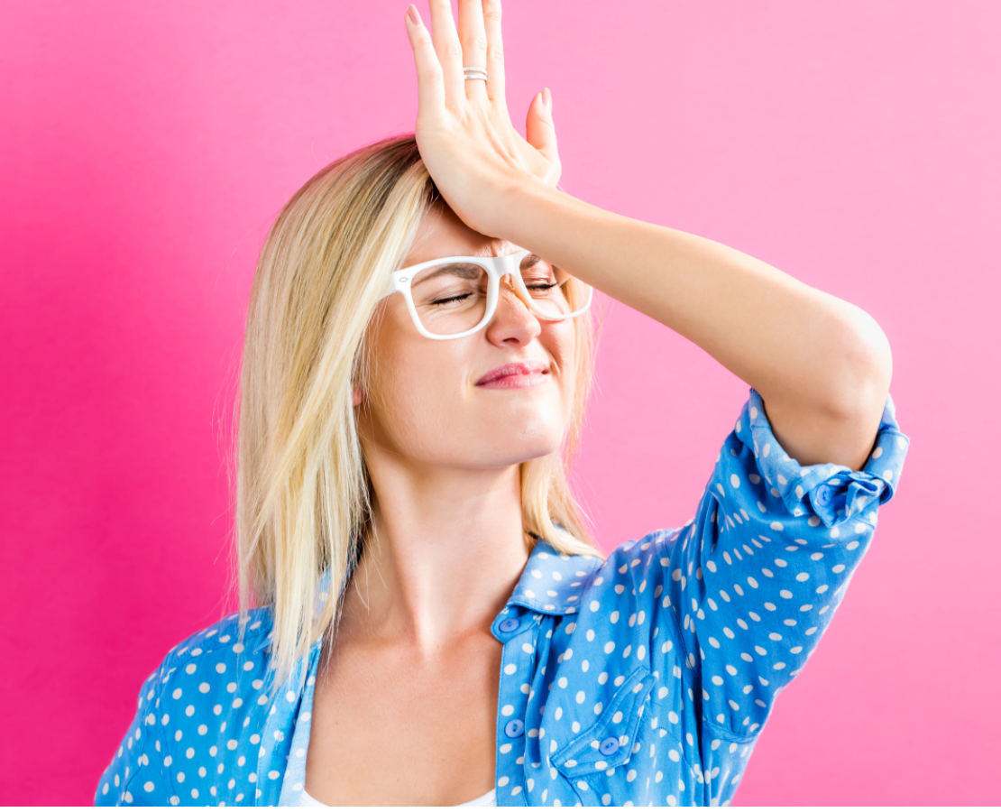 blonde caucasian woman with palm to forehead